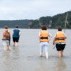 5 People walking in calf-deep water