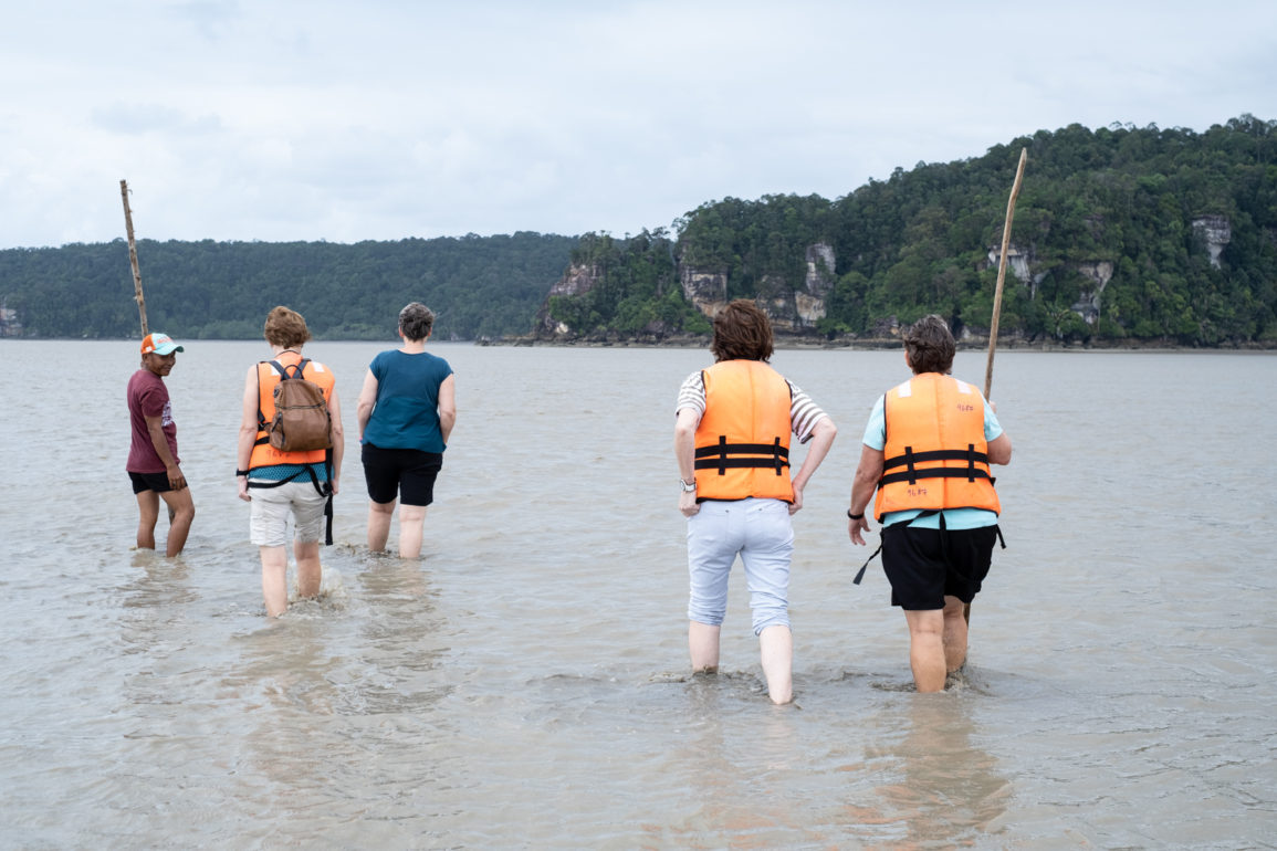 5 People walking in calf-deep water