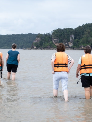 5 People walking in calf-deep water