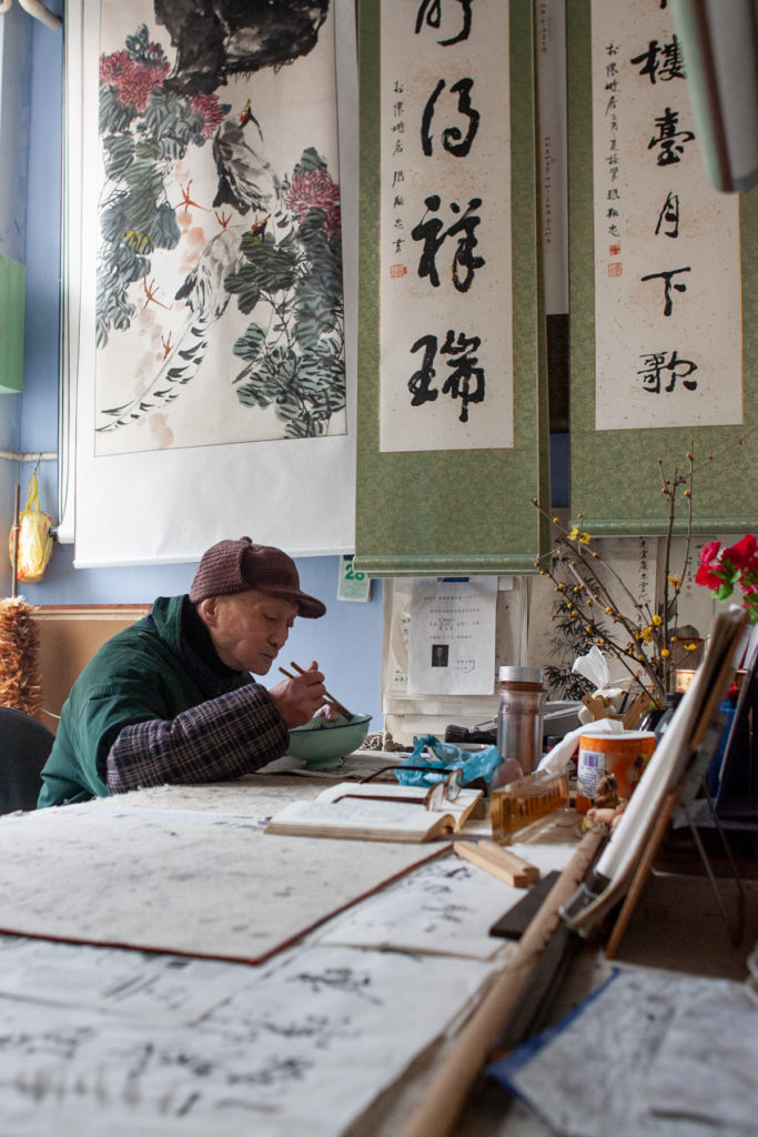 Man eating lunch in painting studio