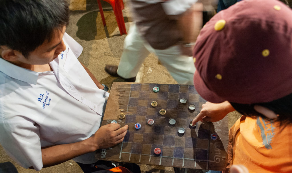 Two men playing checkers