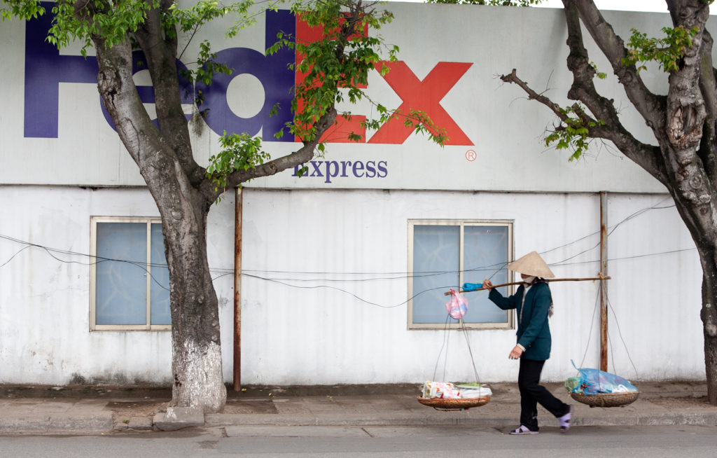 Woman carrying baskets on pole