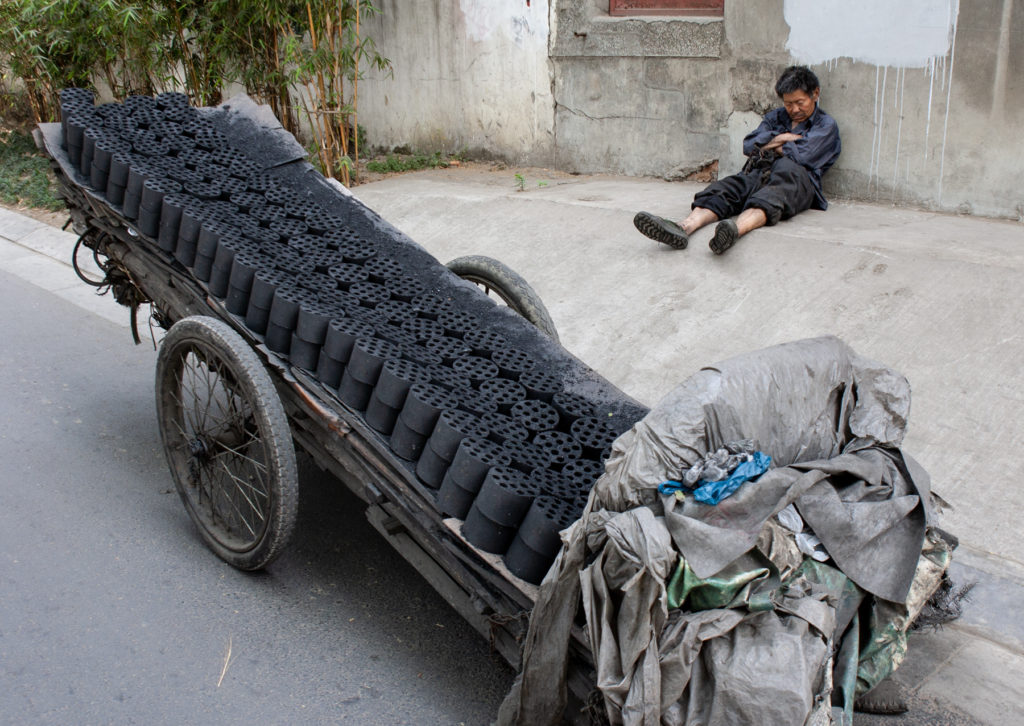 Man sleeping while sitting on streetside