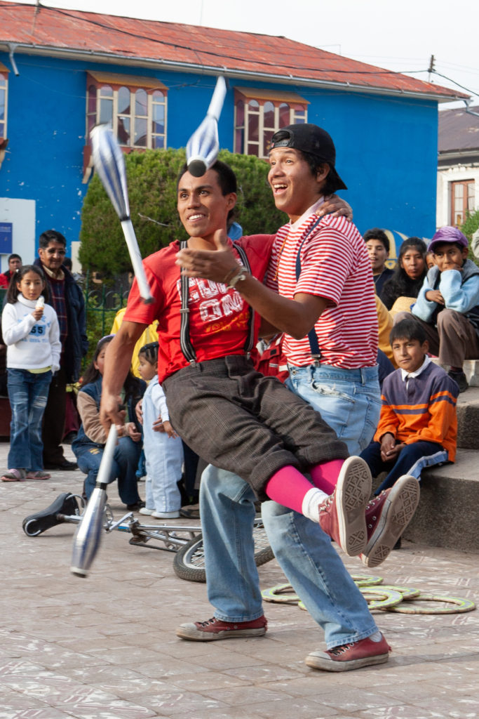 Two men juggling together