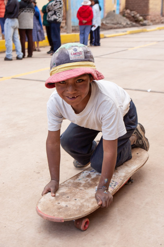 Boy kneeling on skateboard