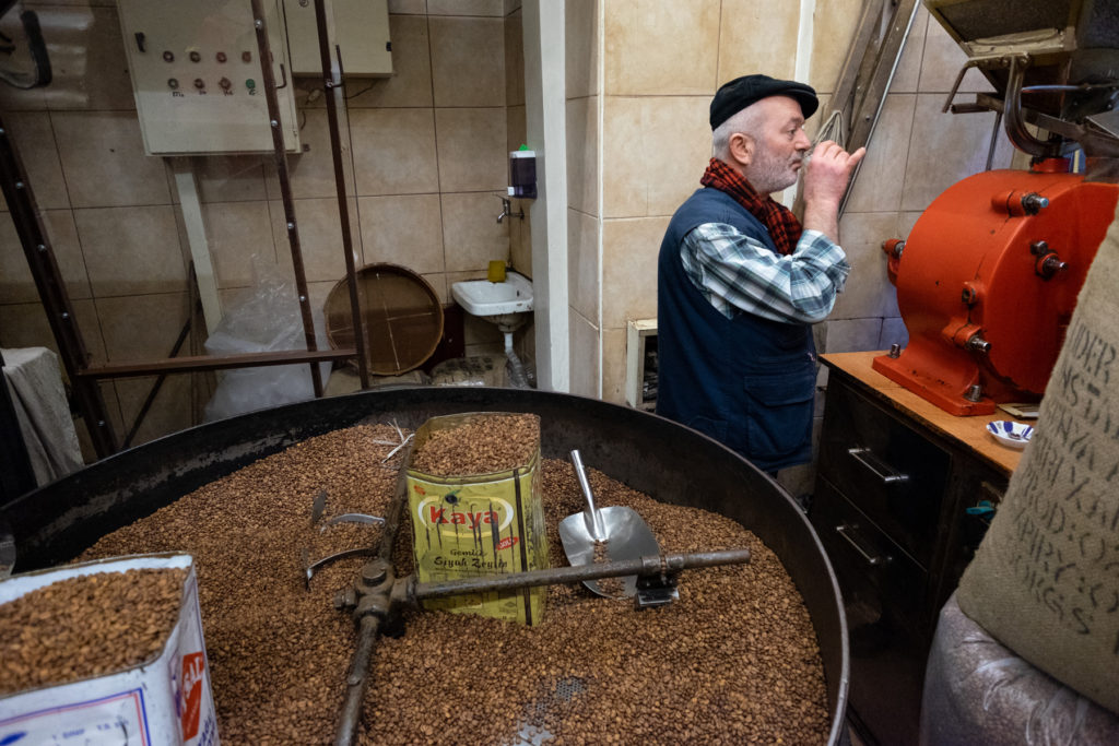 Man drinking coffee in coffee roasting shop