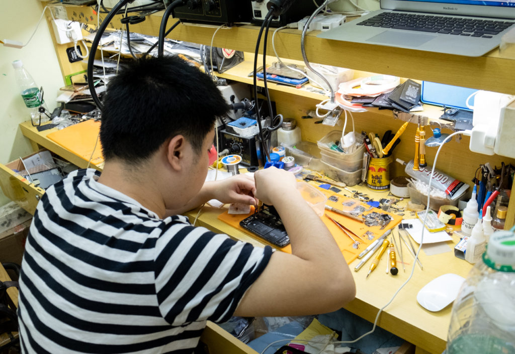 Man working at crowded workbench