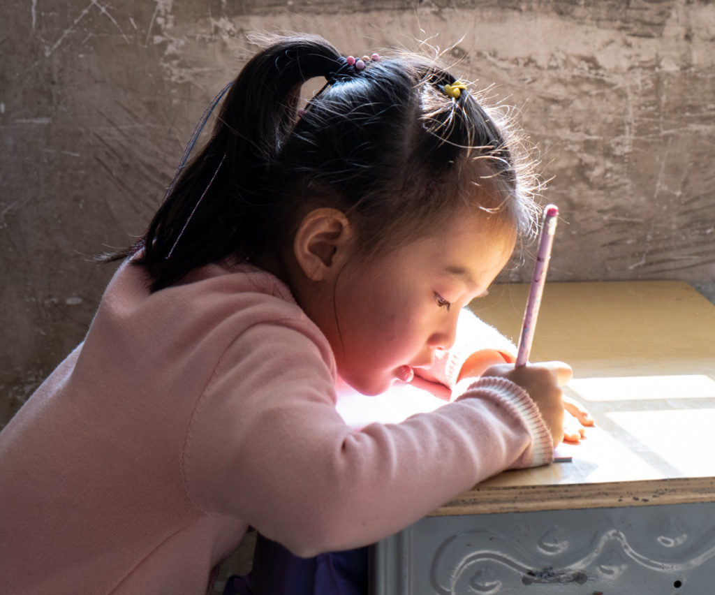 Girl writing with pencil