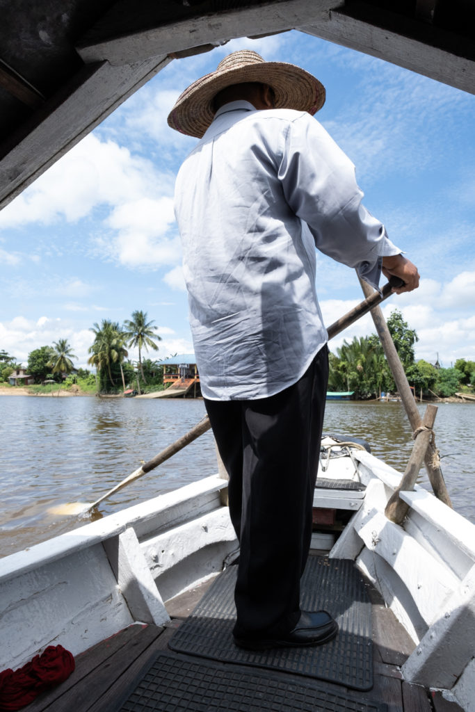 Man steering a boat from the front