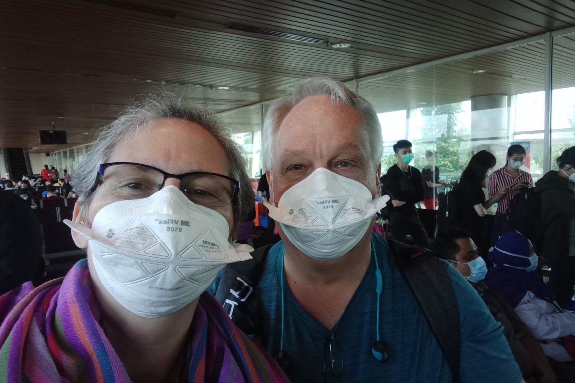 two people wearing masks