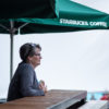 Woman sitting under Starbucks Umbrella