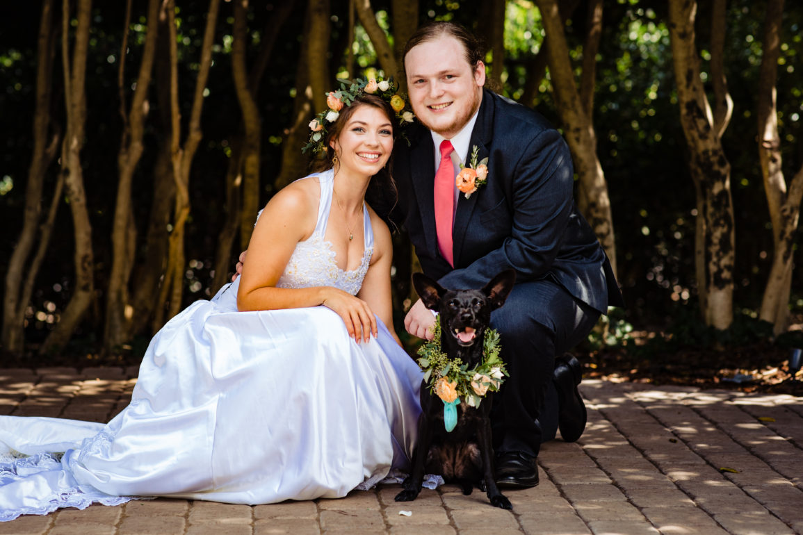 A bride, groom, and dog