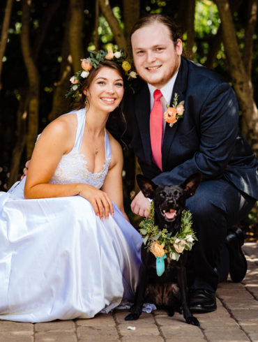 A bride, groom, and dog