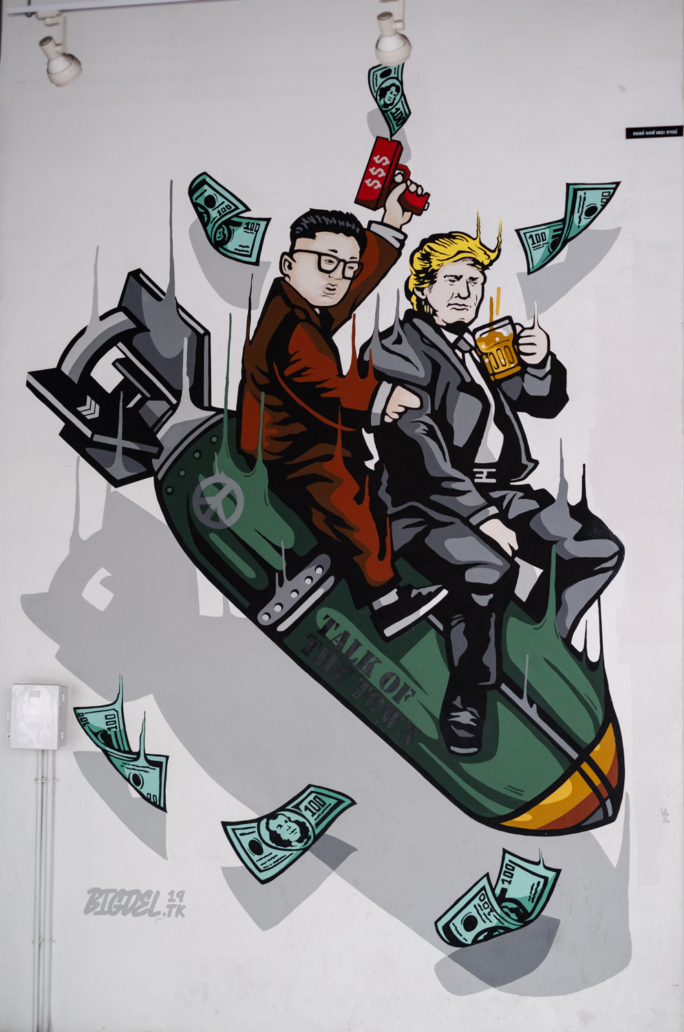 Kim Jong Un and Donald Trump riding a bomb with 100 dollar bills flying around them