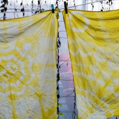 two squares of fabric with yellow tie dye designs