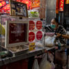 streetside restaurant with three women has Michelin Star signs